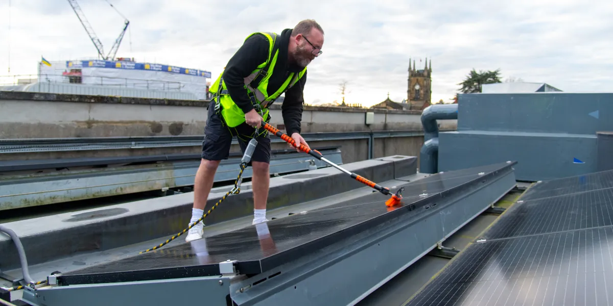 Photo of Darren cleaning the solar panels