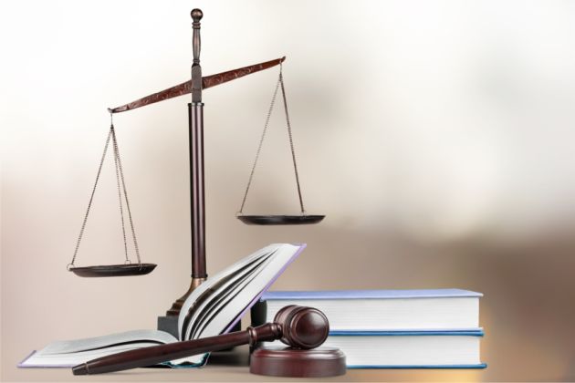 Justice Scales and books and wooden gavel on table